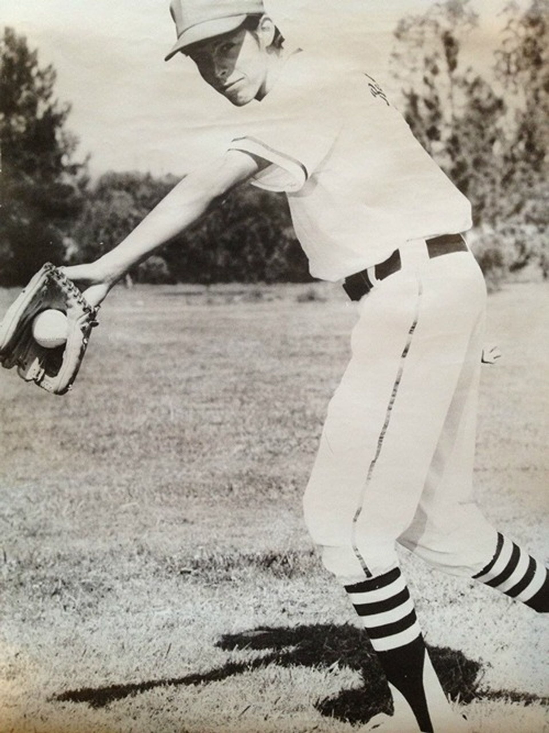 A black and white photo of Tom Wright throwing a ball