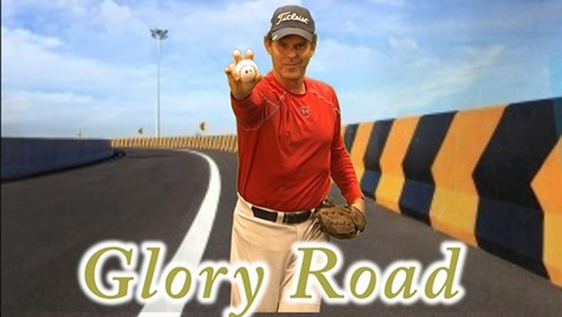 Tom Wright in a red shirt holding a baseball in front of a sign that says Glory Road