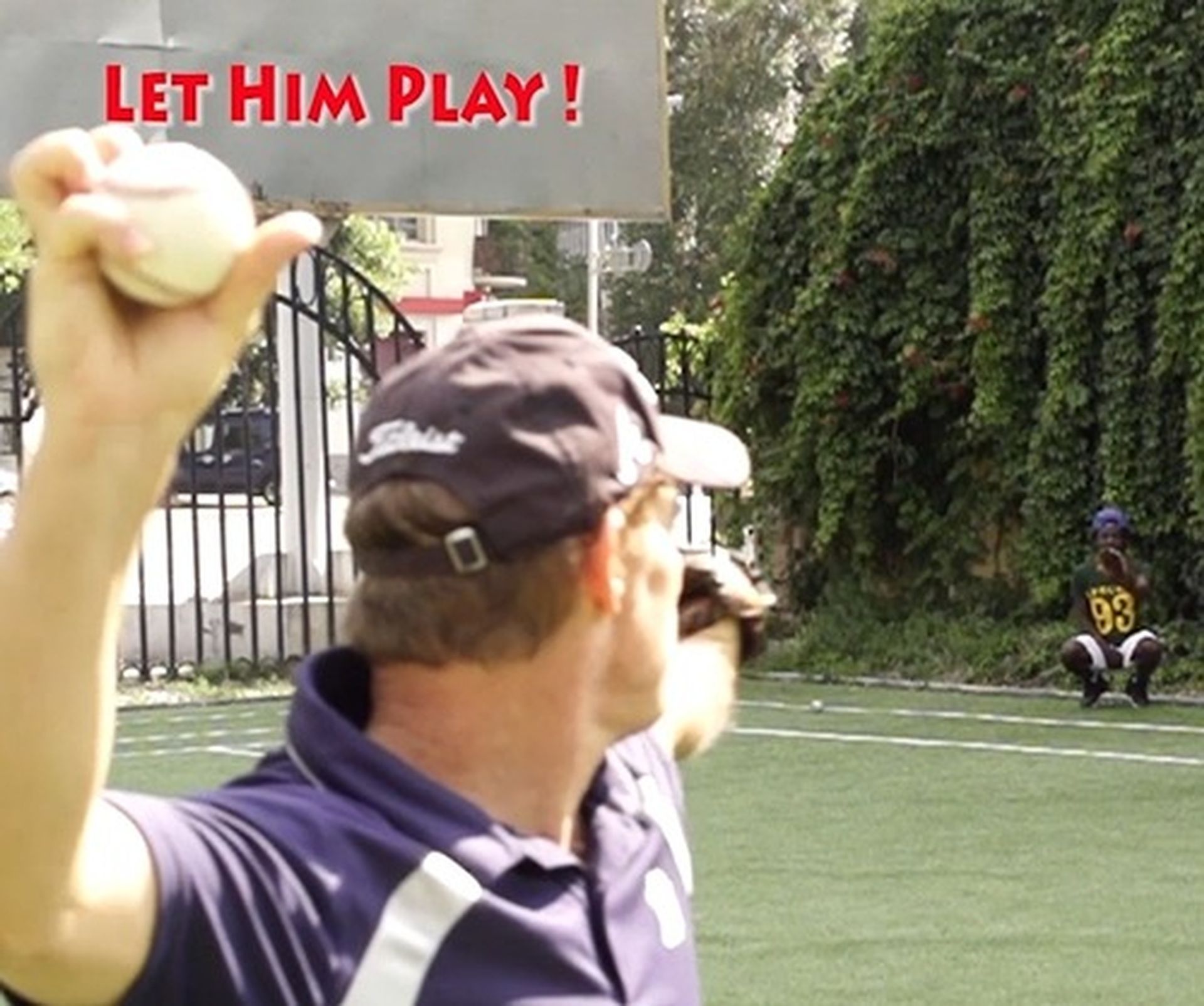 Tom Wright is throwing a baseball in front of a sign that says let him play