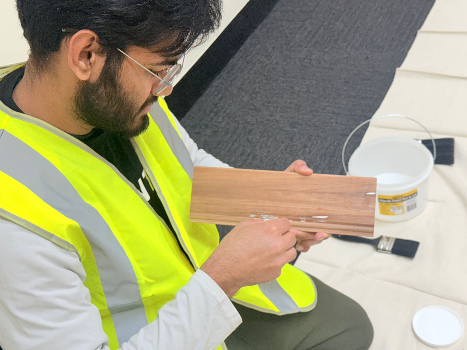 People in a classroom setting, participating in a CPR training session. Two mannequins are on the floor.