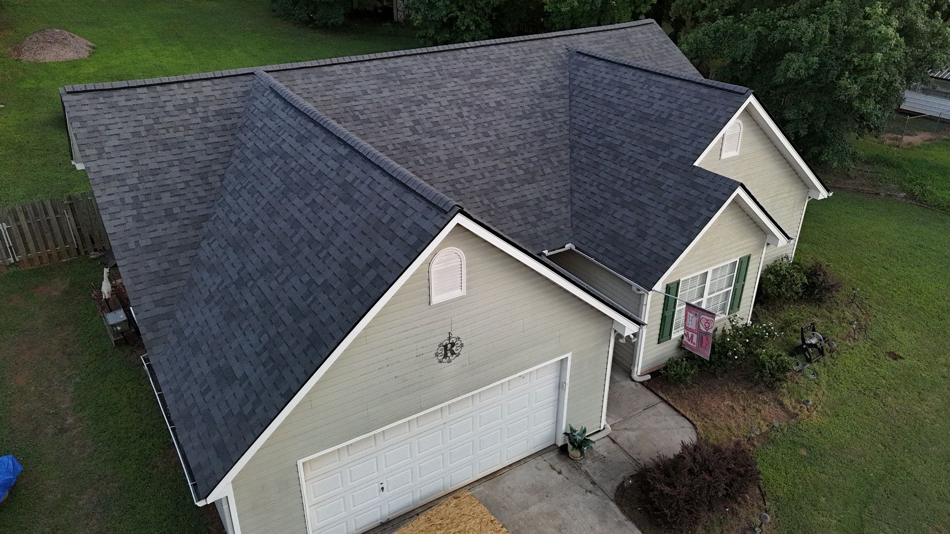 An aerial view of a house with a new roof.