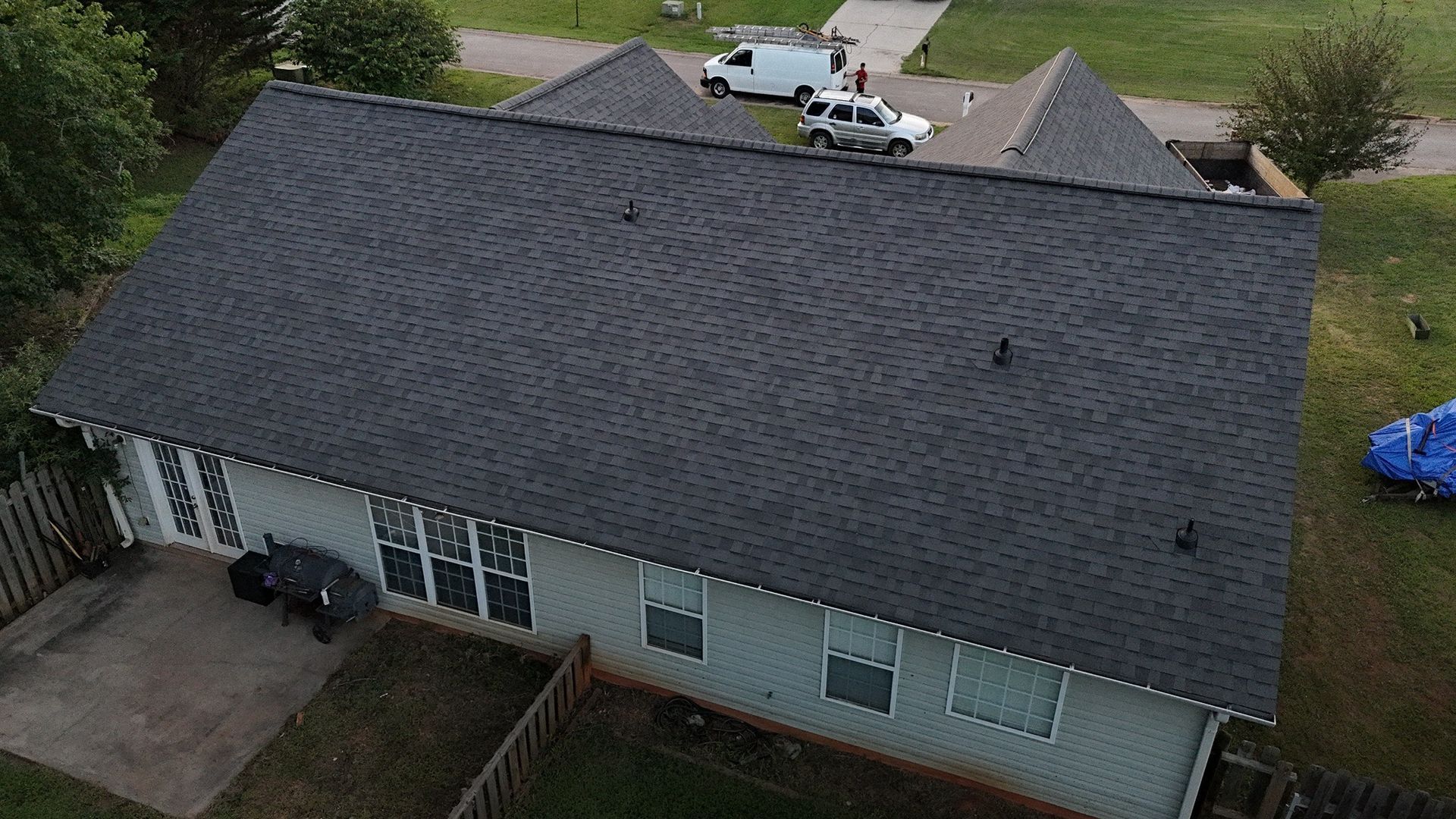 An aerial view of a house with a roof that has been installed.