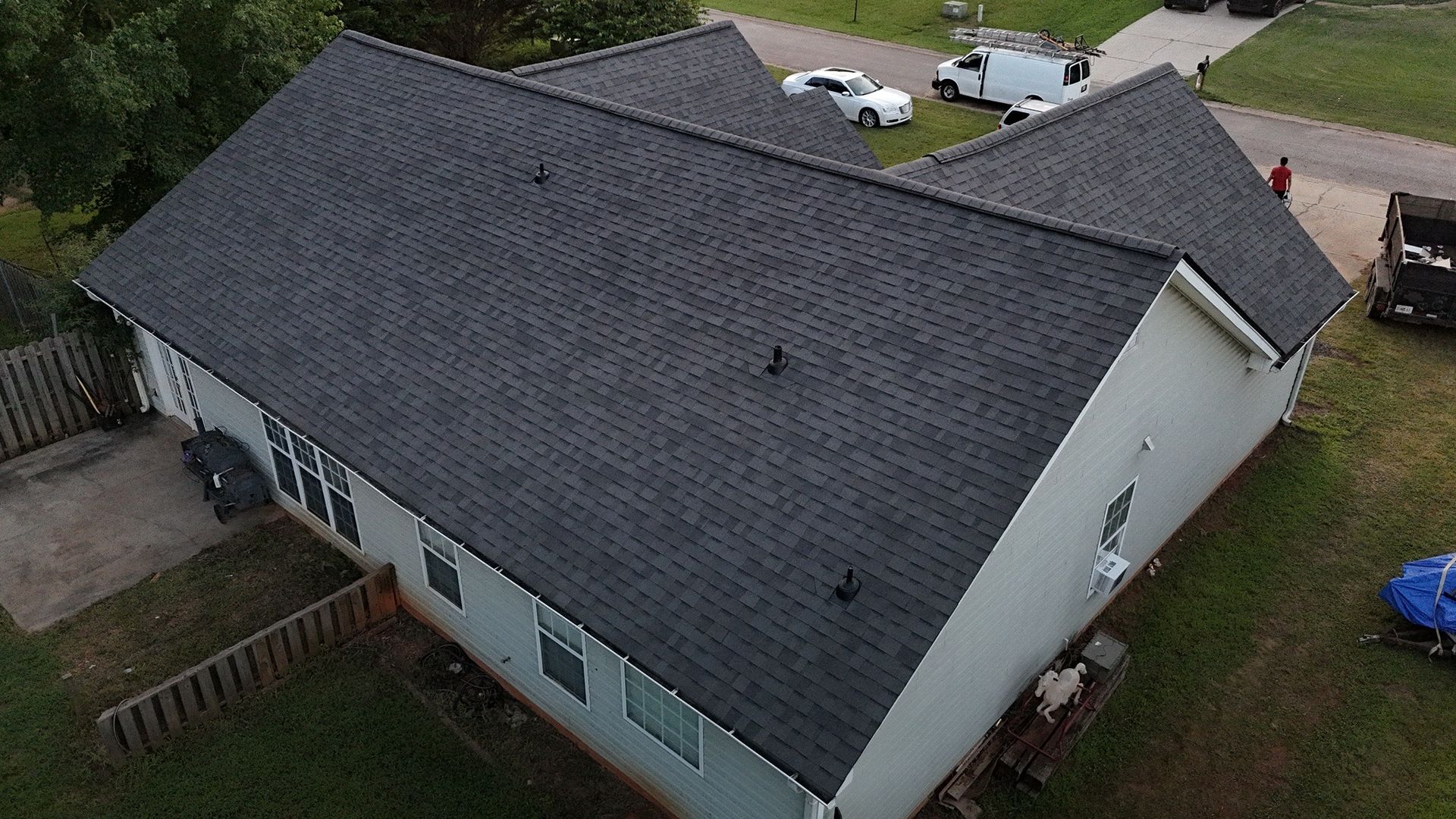 An aerial view of a house with a new roof.