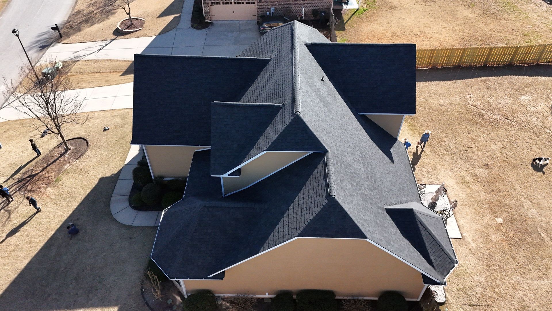 An aerial view of a house with a black roof