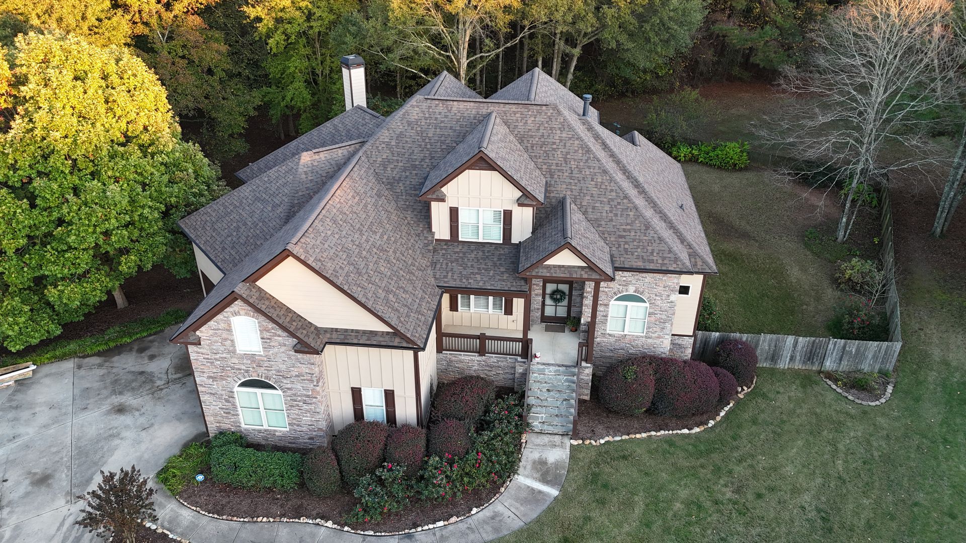 An aerial view of a large house surrounded by trees.