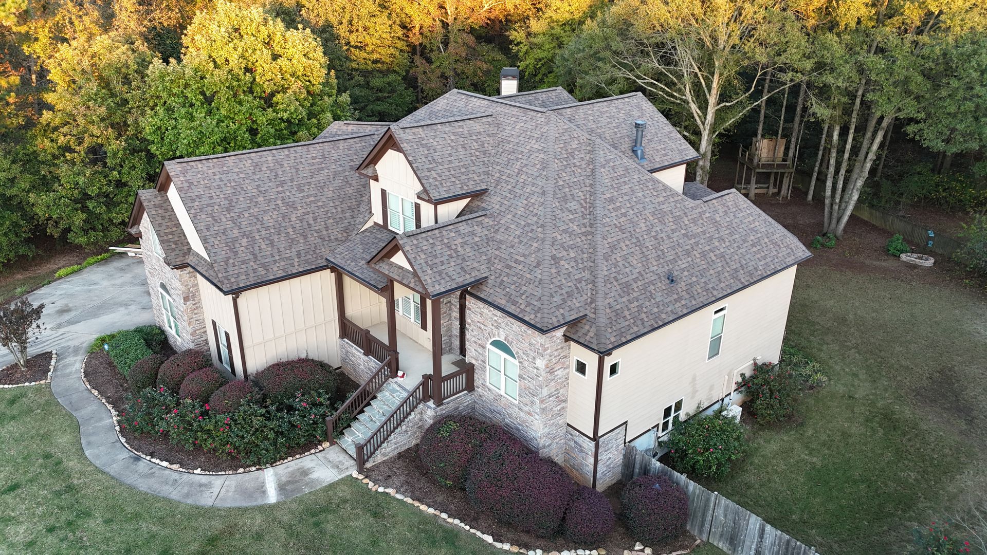 An aerial view of a large house surrounded by trees.