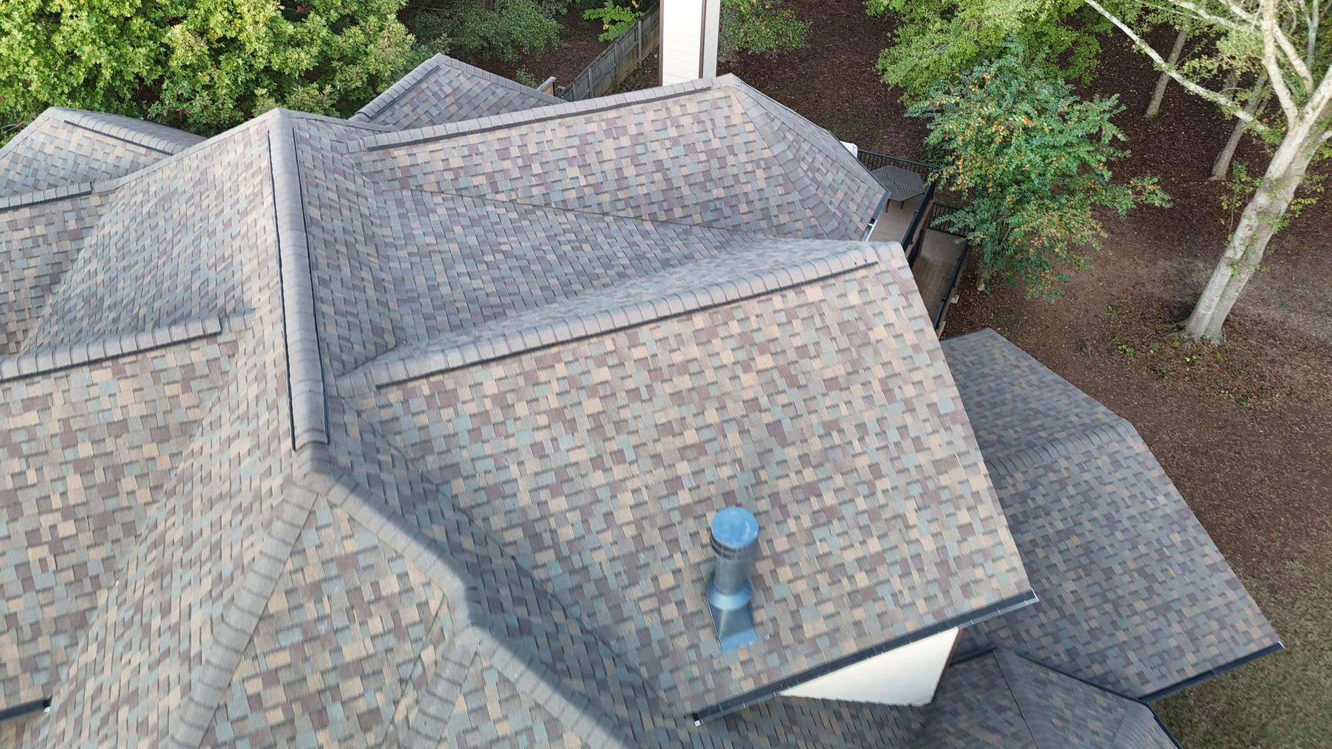An aerial view of a roof of a house with a chimney.