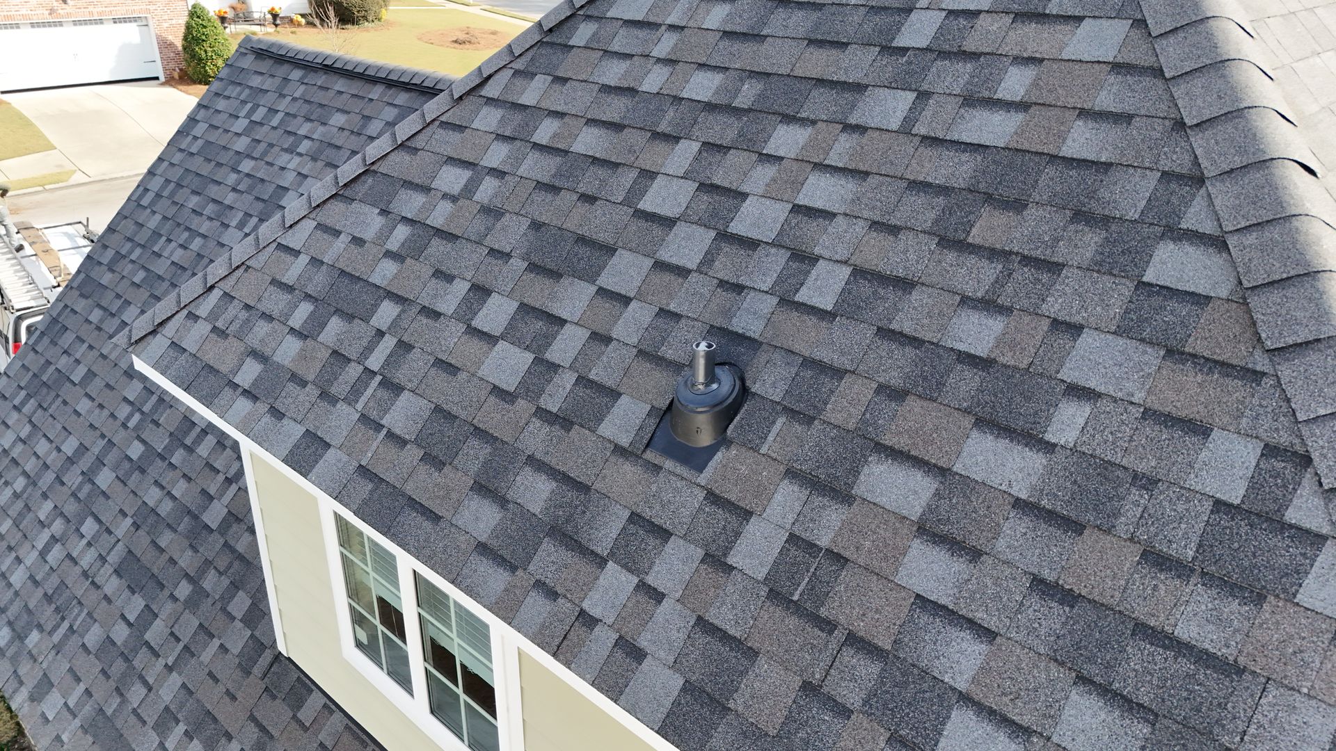 An aerial view of a roof of a house with shingles.