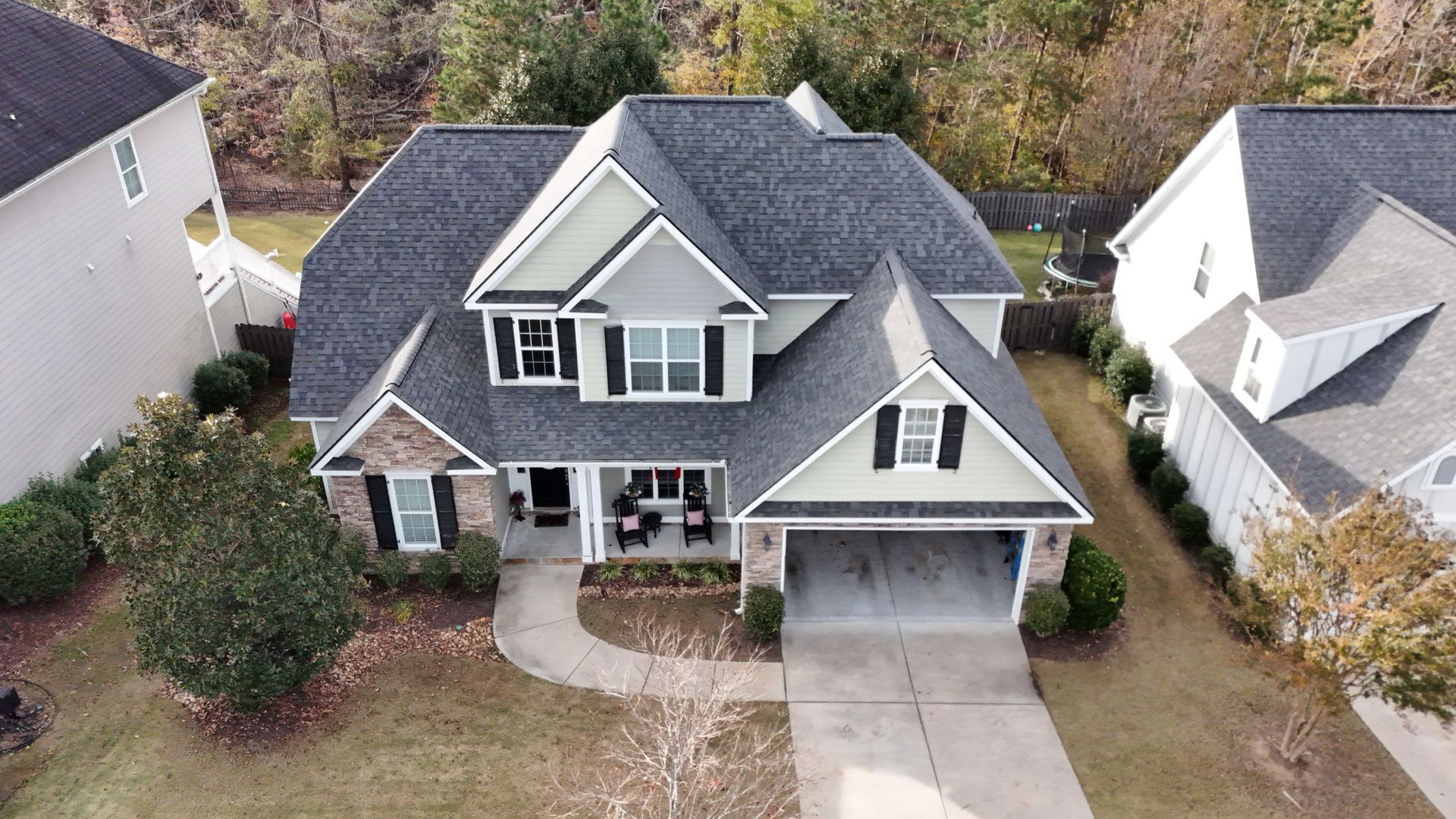 An aerial view of a large house in a residential area.