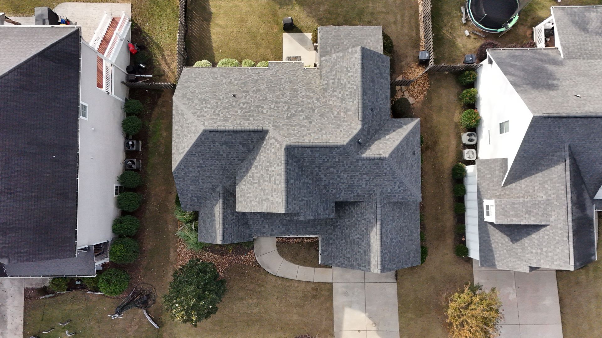 An aerial view of a residential neighborhood with houses and driveways.