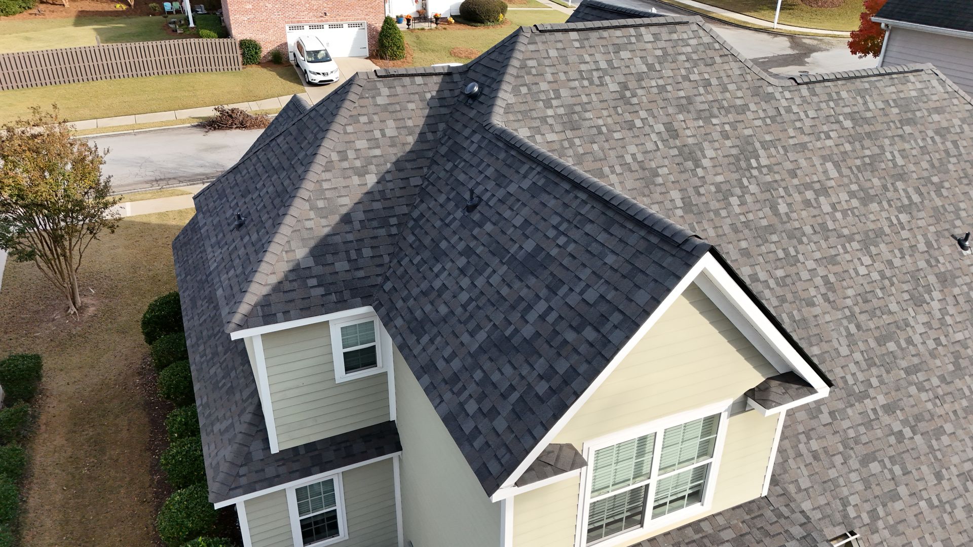 An aerial view of a house with a new roof.