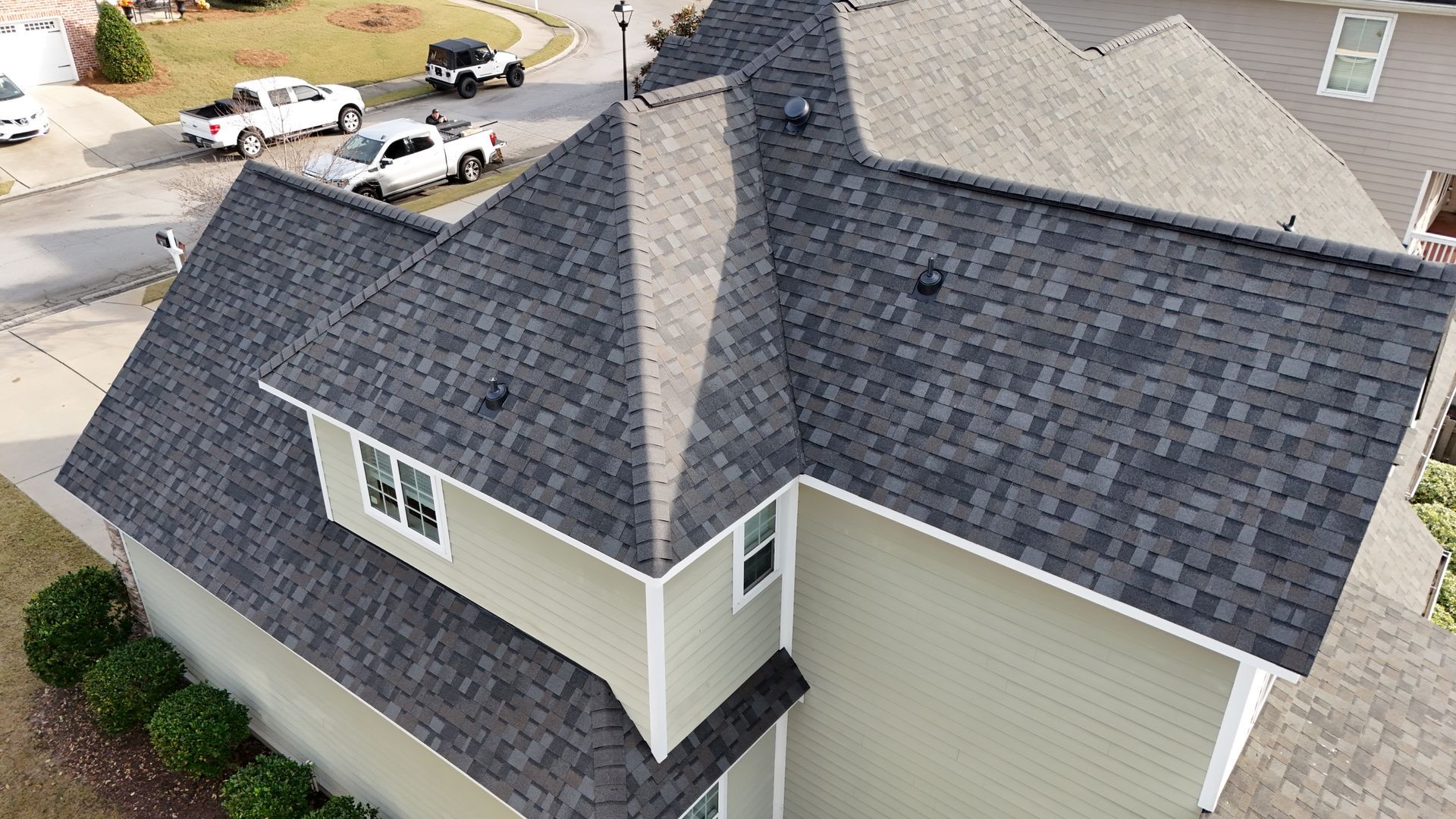An aerial view of a house with a new roof.