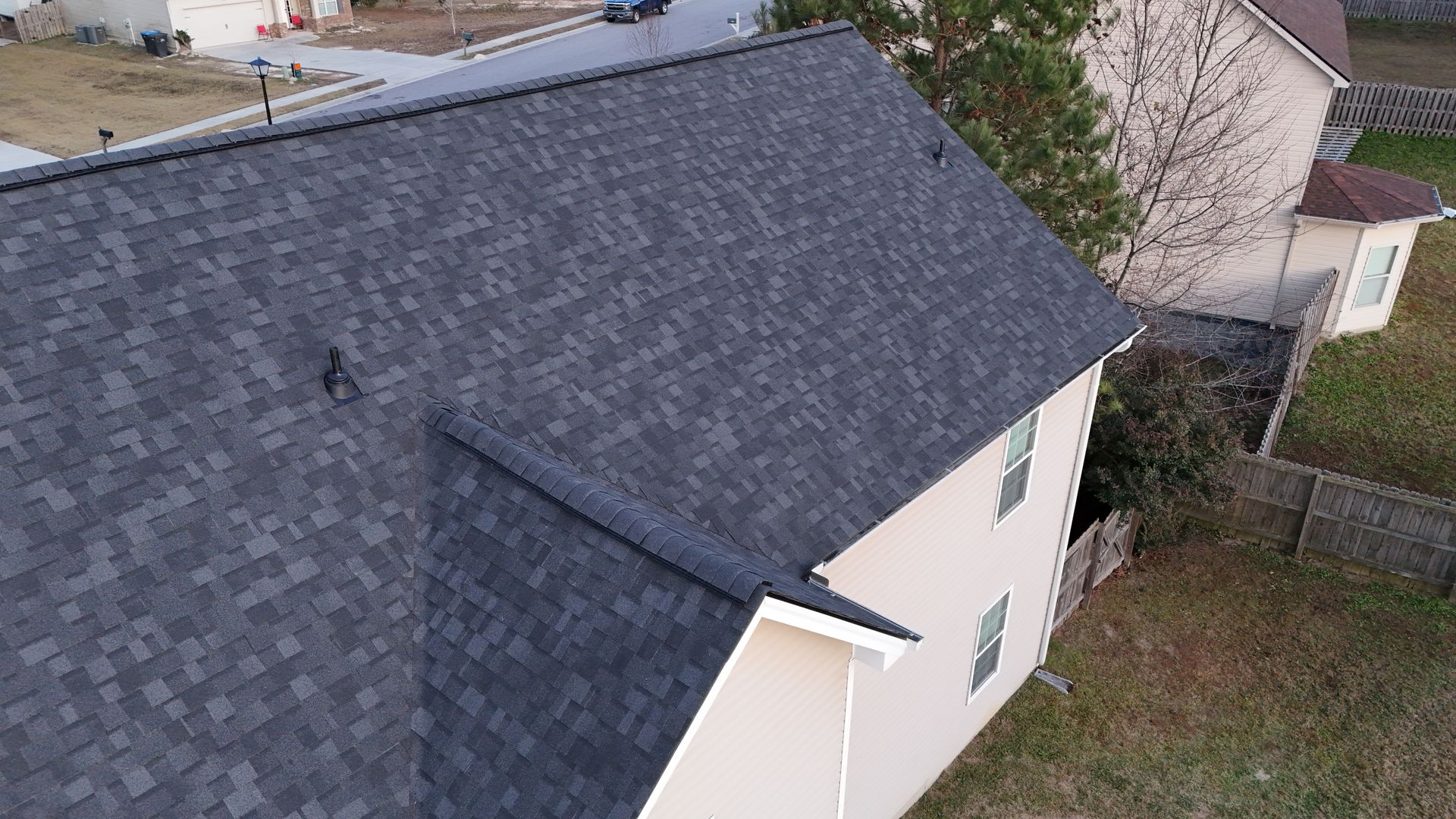 An aerial view of a house with a new roof.