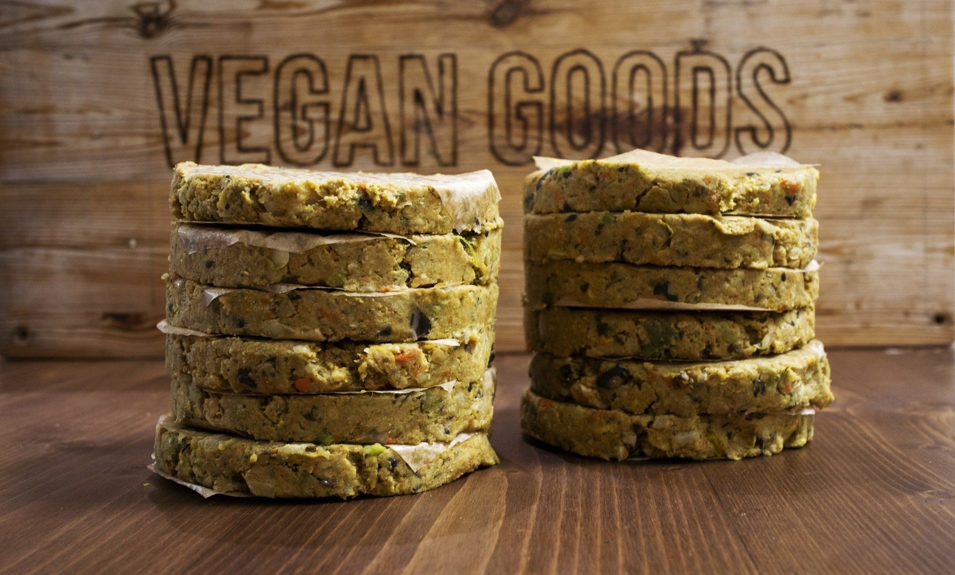 Two stacks of vegan goods are sitting on a wooden table