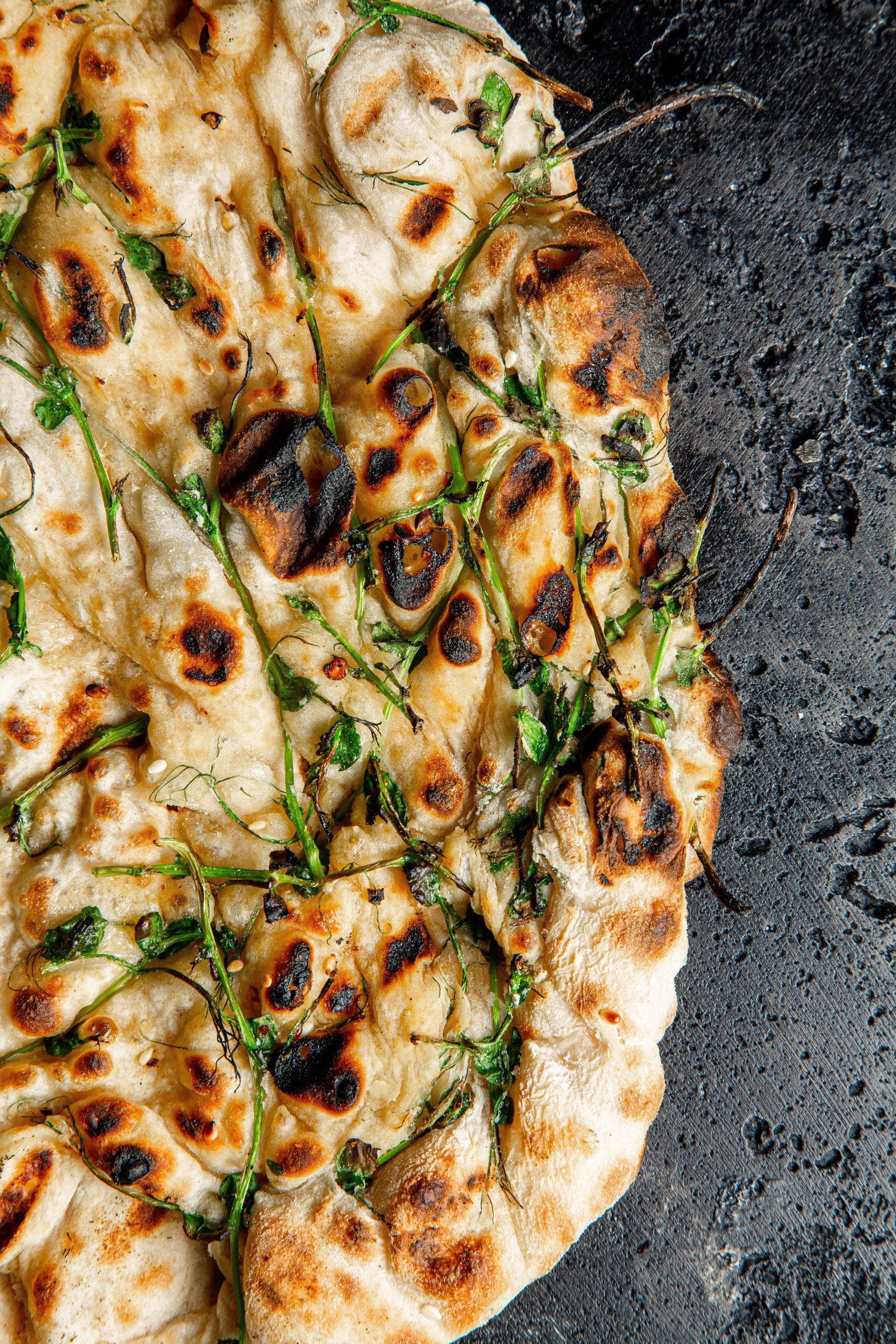 A close up of a pizza on a pan on a table.