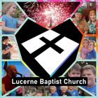 The logo for lucerne baptist church has a cross on it