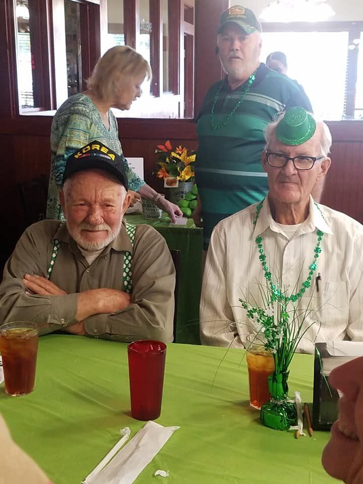 A group of men are sitting at a table in a restaurant.