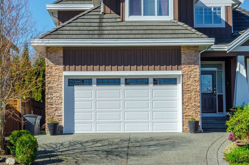 Large House With a White Garage Door and a Driveway — Coffs Garage Doors & Motors in Toormina, NSW