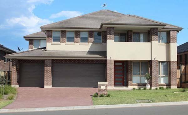Large House With Two Garages and a Brick Facade — Coffs Garage Doors & Motors in Coffs Harbour, NSW