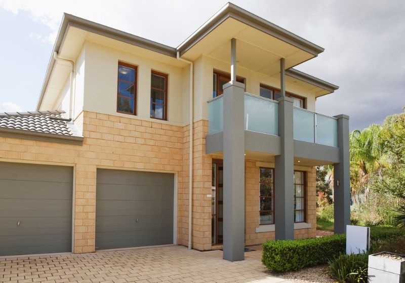 Large House With Two Garage Doors and a Balcony — Coffs Garage Doors & Motors in Toormina, NSW