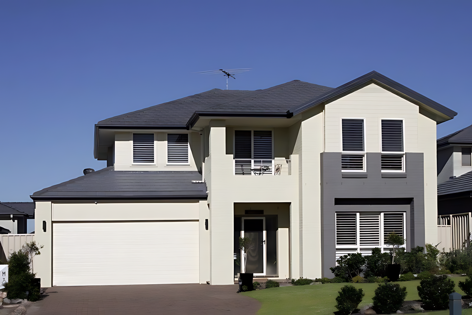 Large White House With a Gray Roof — Coffs Garage Doors & Motors in Toormina, NSW