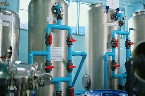 A Room Filled With Stainless Steel Tanks And Blue Pipes - Oklahoma City, OK - Total Pump & Supply