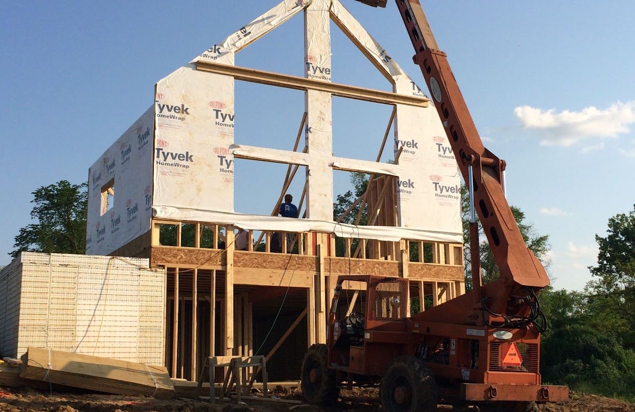 A crane is lifting a building that is being built