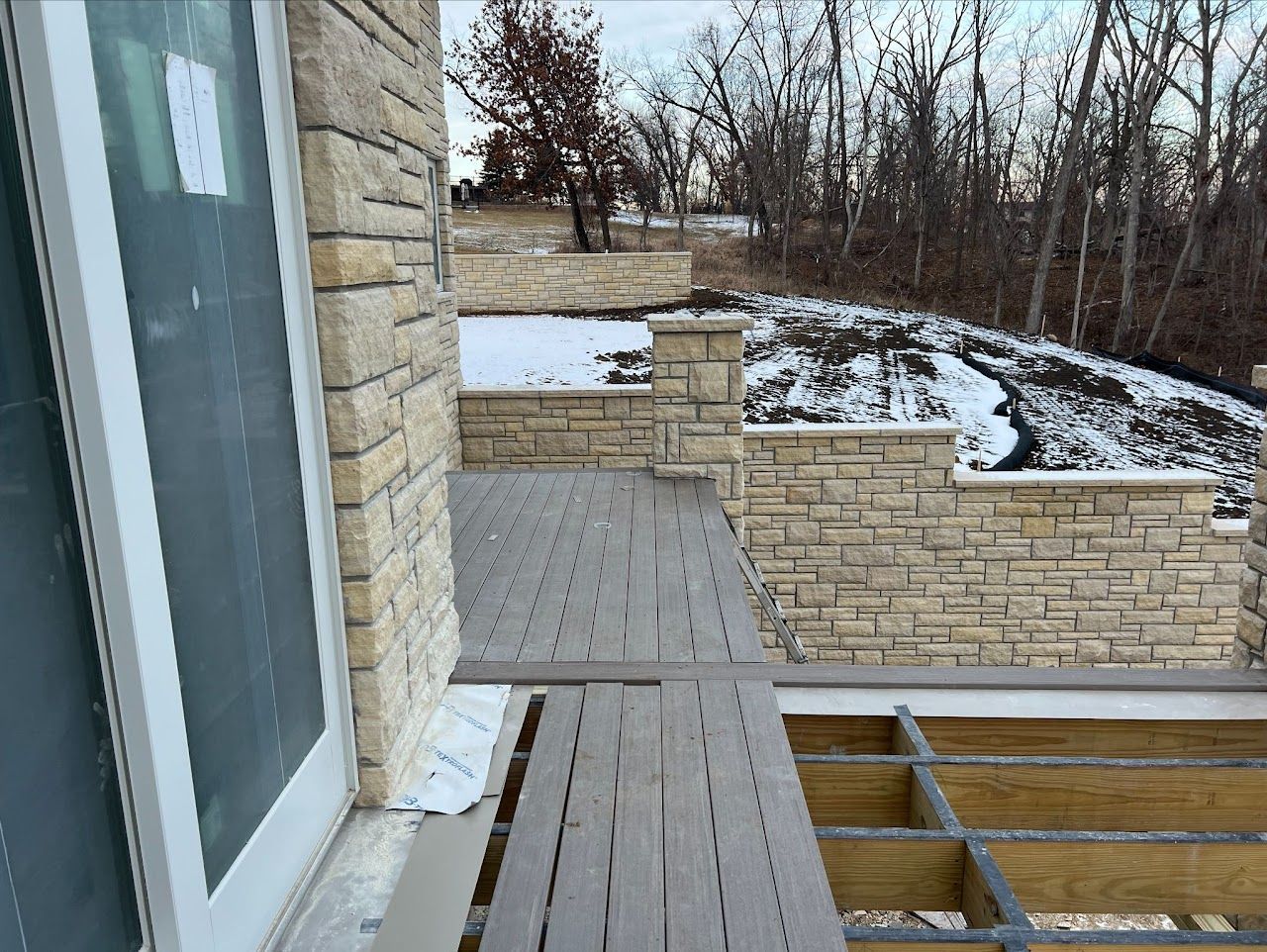 A brick building with a wooden deck in front of it