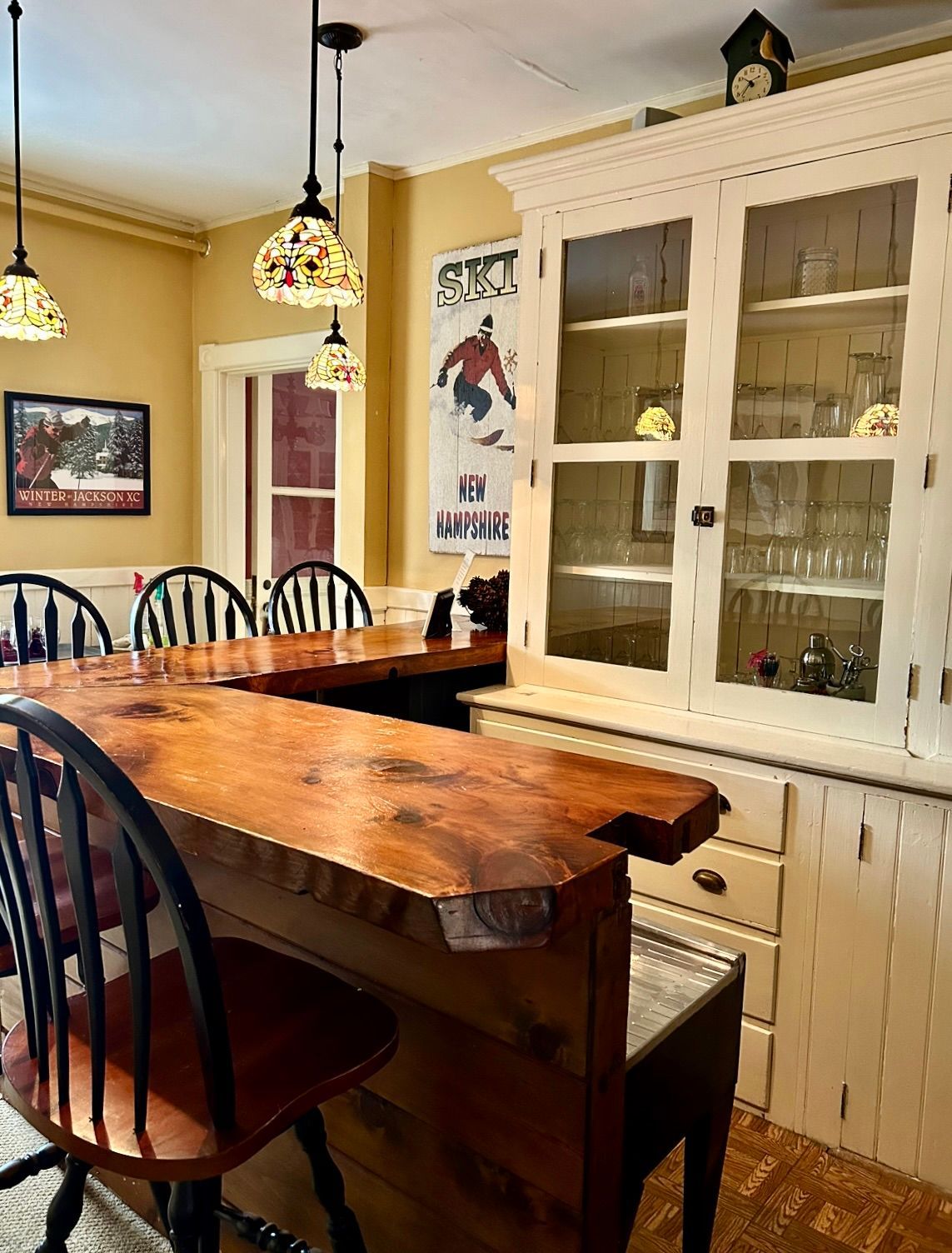 A kitchen with a large wooden table and chairs