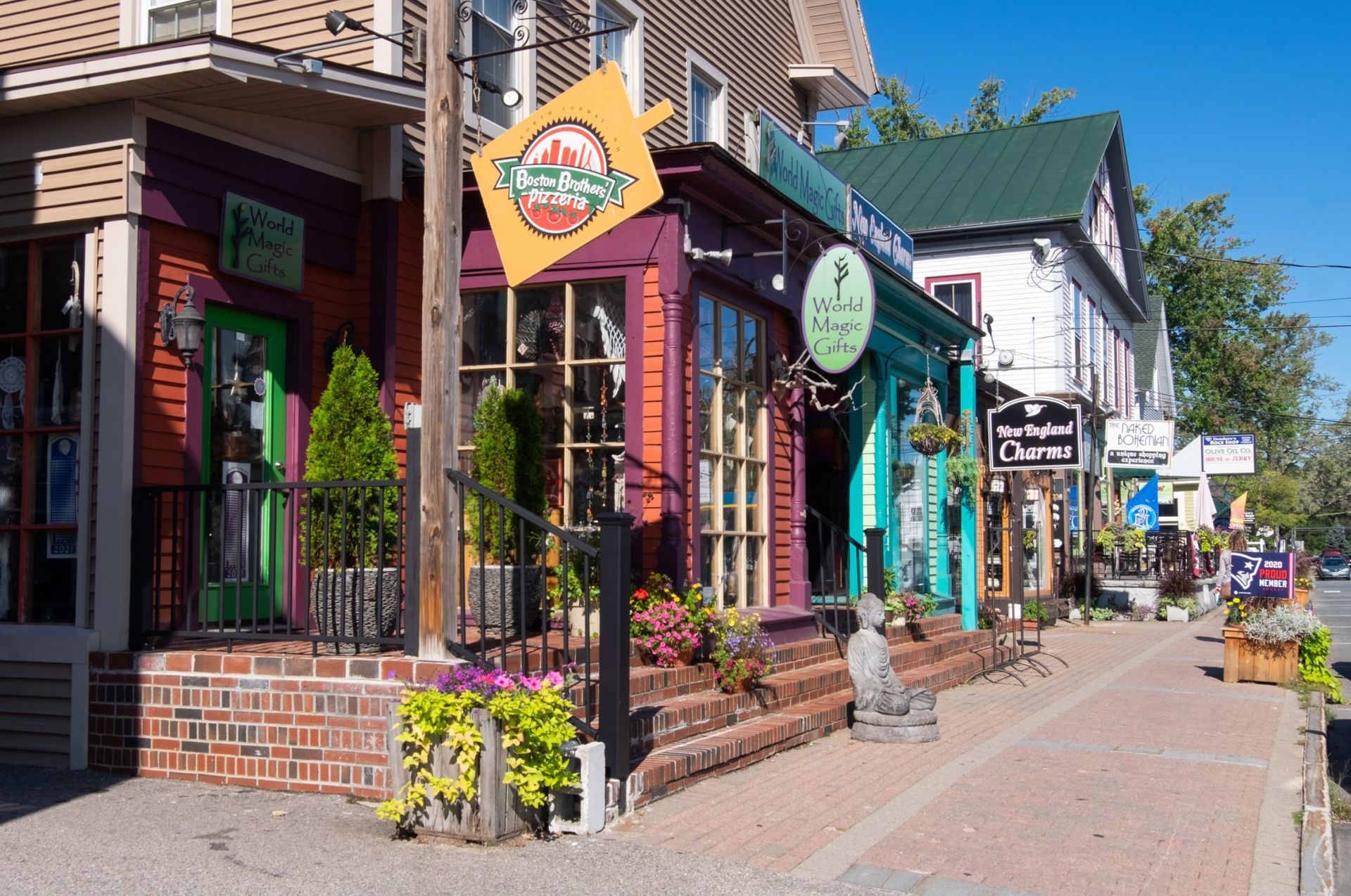 A row of shops on a sidewalk in a small town