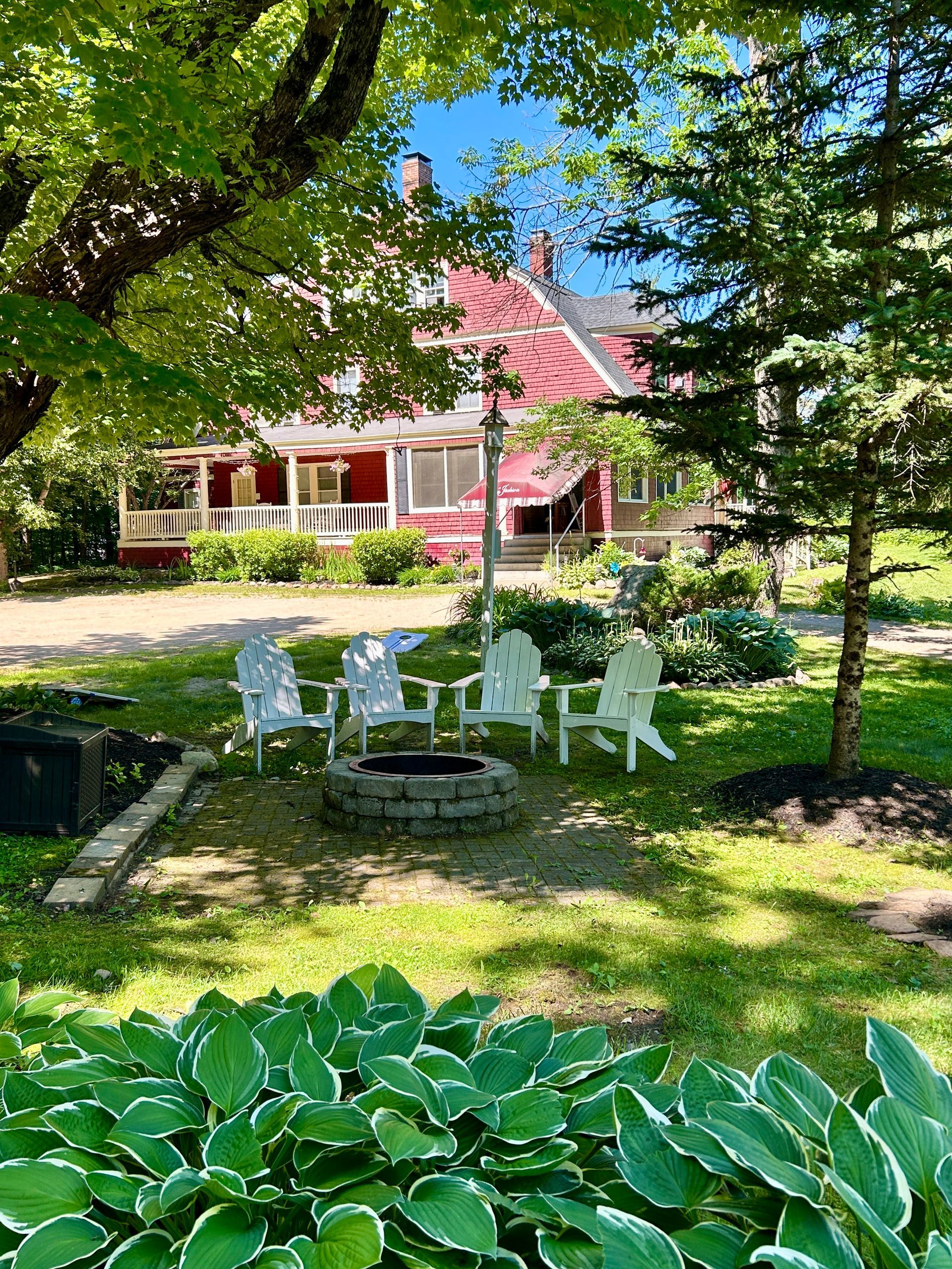 There is a fire pit in the middle of the grass in front of a house.