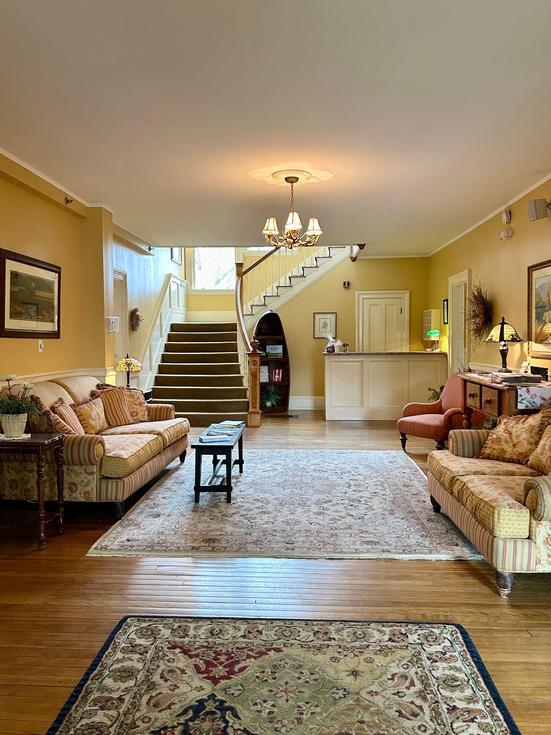 A living room filled with furniture and a rug.