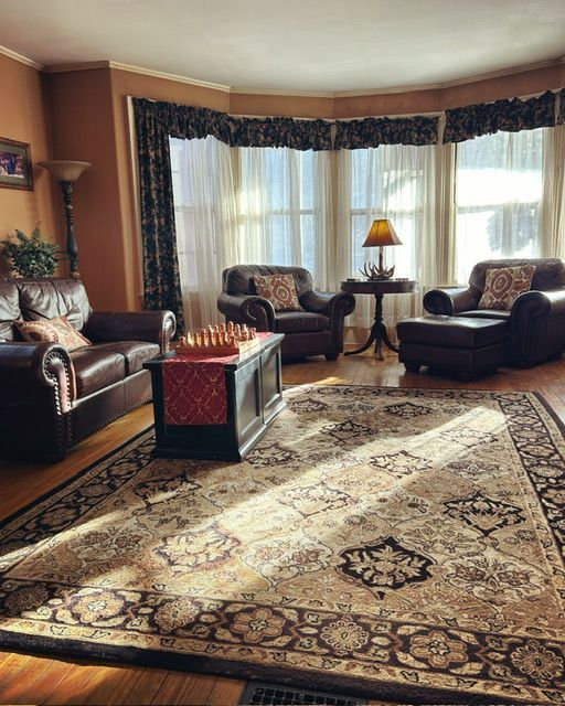 A living room filled with furniture and a rug