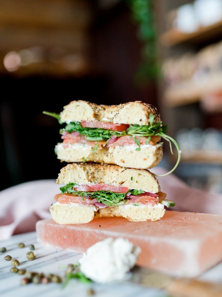 A bagel sandwich is stacked on top of each other on a table.