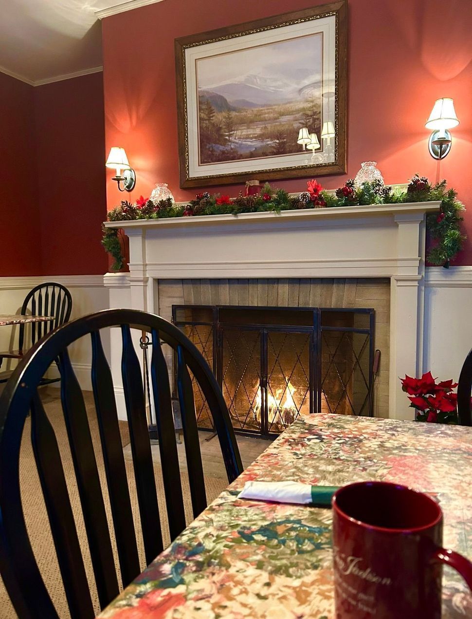 There is a fireplace in the background and a picture on the mantle.