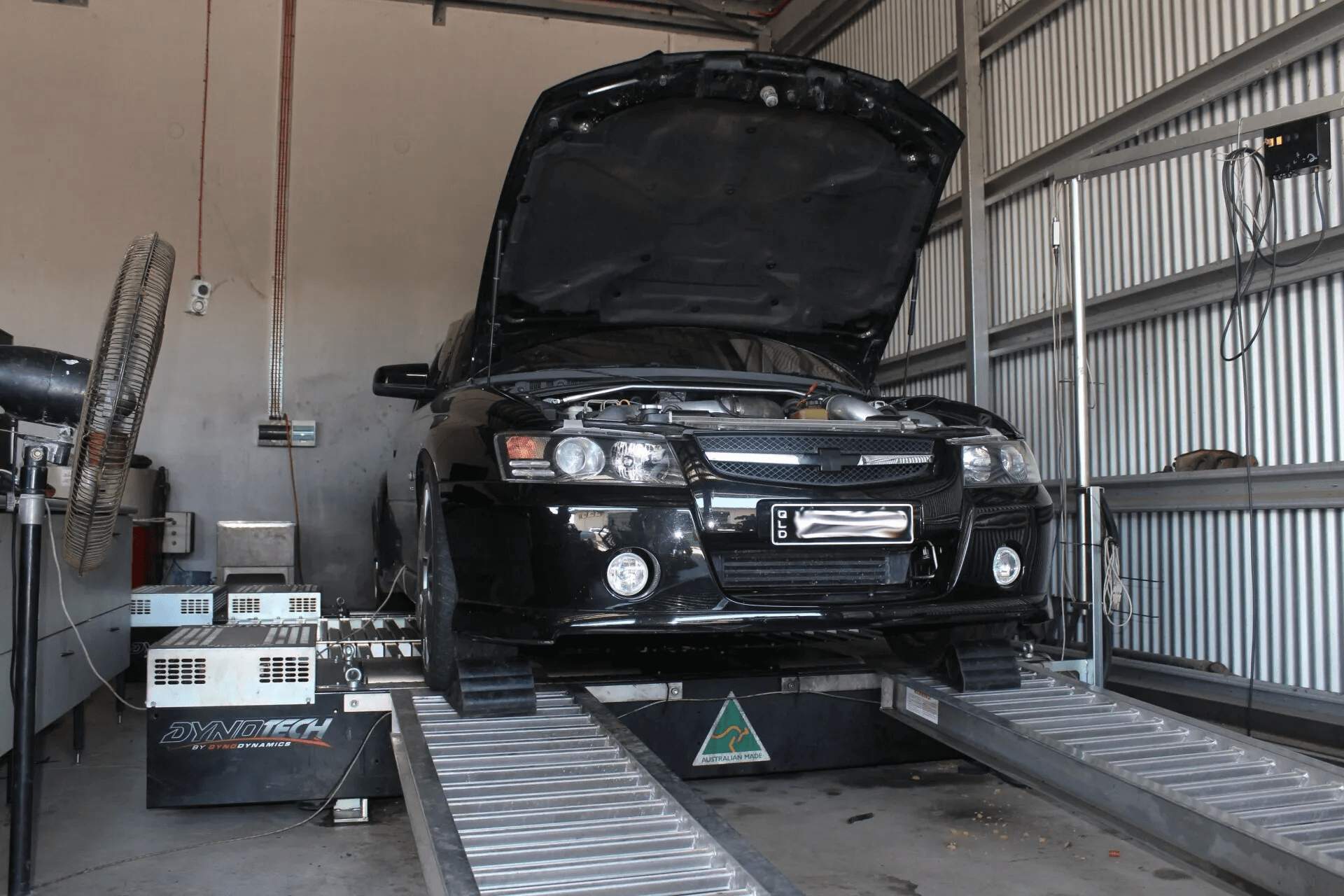 Black Car in Mechanic Workshop — DEM Automotive in Edmonton, QLD