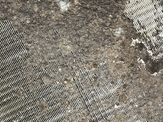A close up of a piece of fabric with a gray and white pattern.