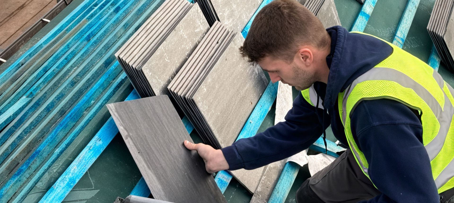 A man is working on the roof of a building.