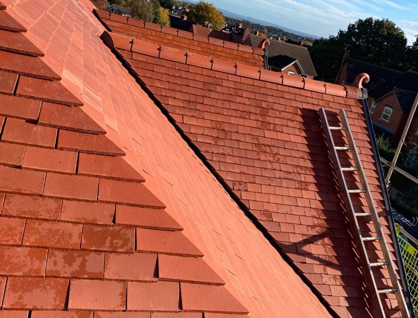 A red tiled roof with a ladder attached to it