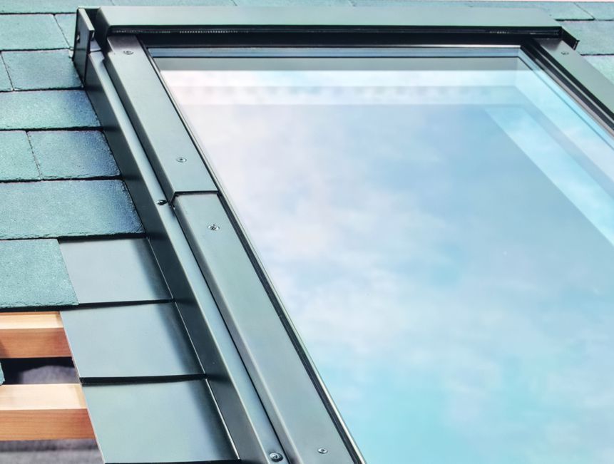 A skylight on top of a roof with shingles