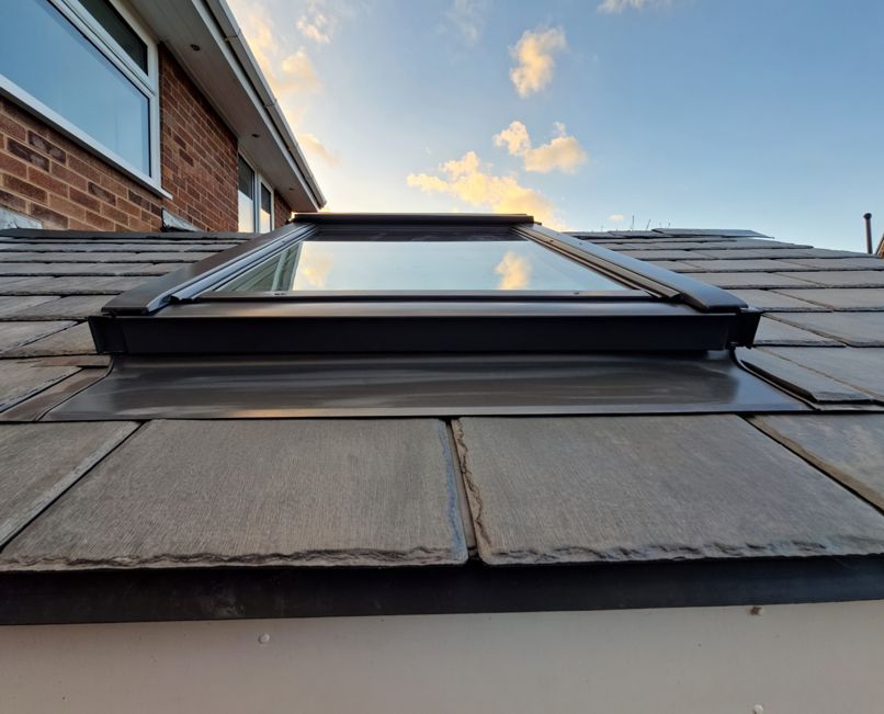 A skylight is on the roof of a house.