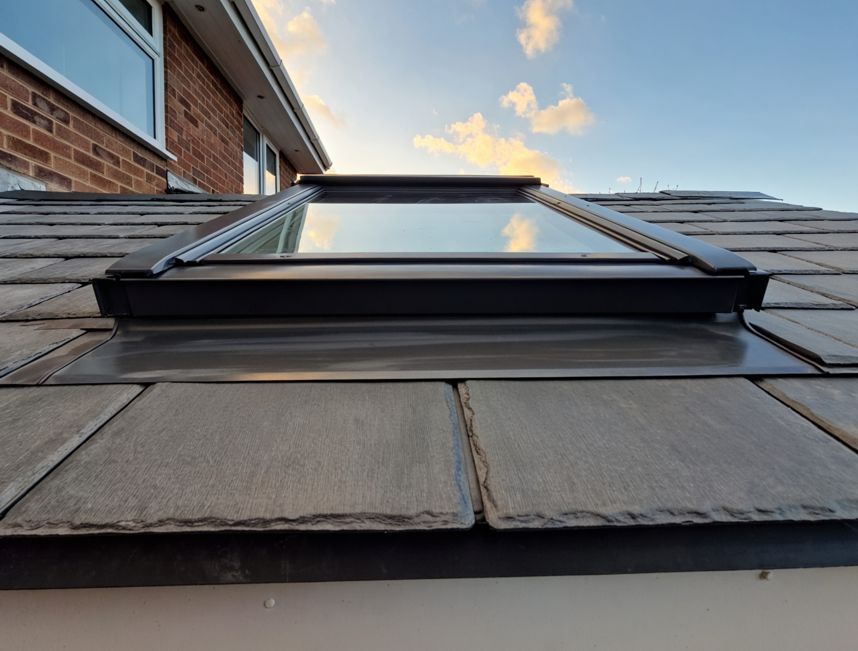 A skylight is on the roof of a house.