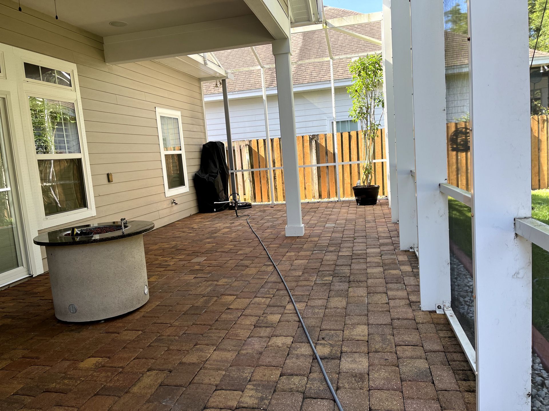There is a fire pit on the patio of a house.