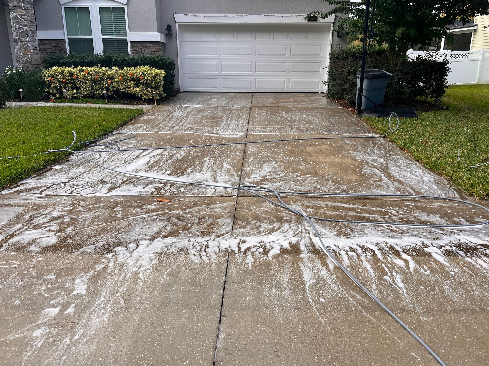 A driveway leading to a house with a white garage door