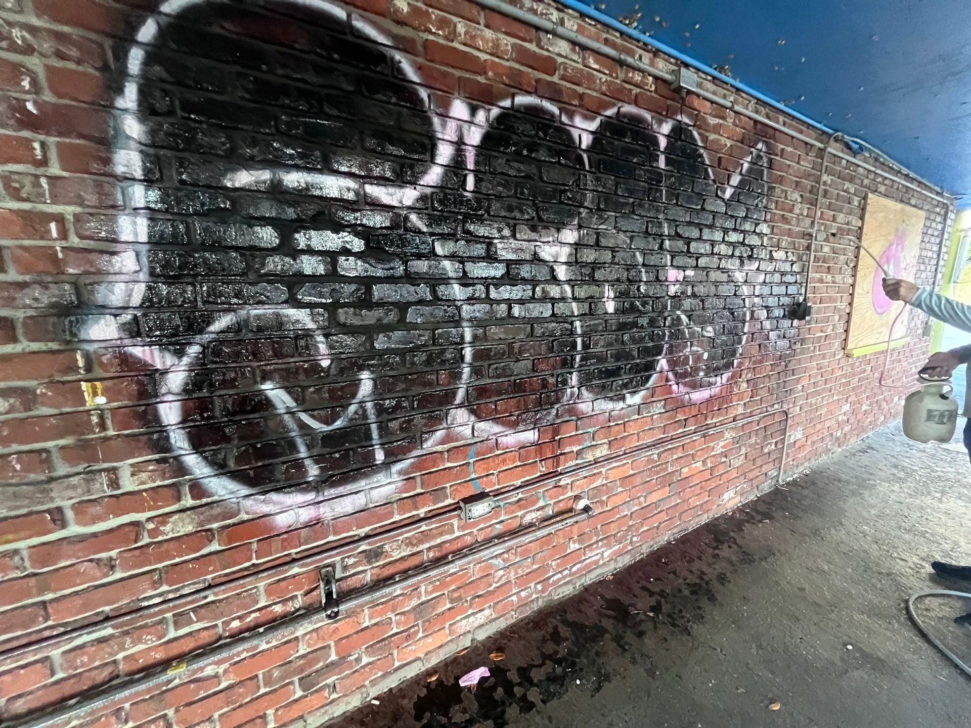 A white fence is sitting in the grass next to a body of water.