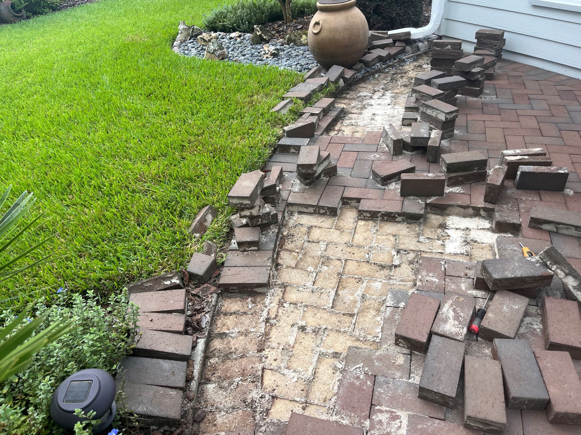 A bunch of bricks are laying on the ground on a sidewalk