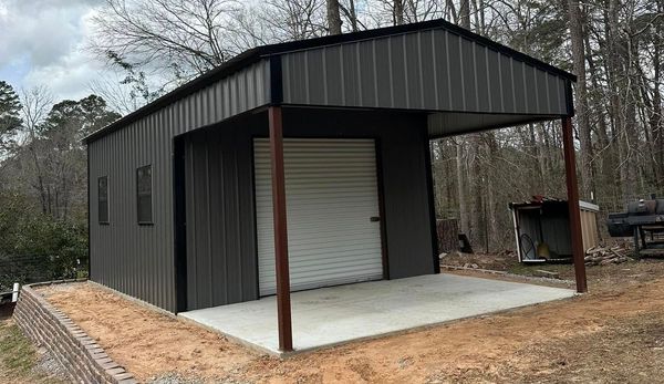 A gray house with a white garage door and a porch.