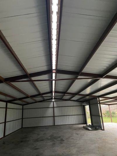 A gray house with a white garage door and a porch.