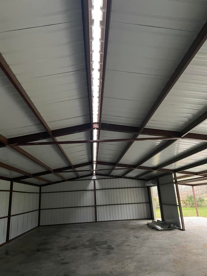 A gray house with a white garage door and a porch.