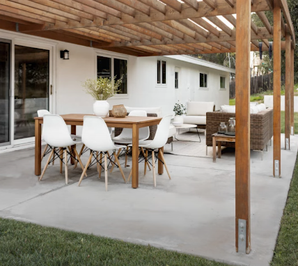 Gray tiled patio with white grout, a dark shadow, and a glass door.